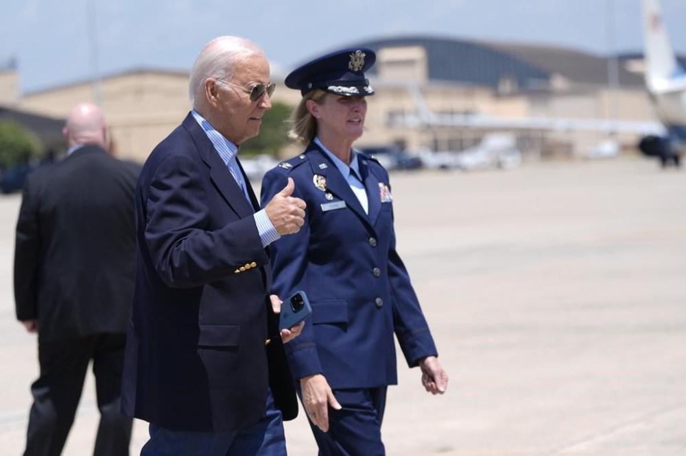 President Joe Biden, left, gestures before boarding Air Force One at Andrews Air Force Base, Md., as he leaves for a campaign trip to Madison, Wis., Friday, July 5, 2024. (AP Photo/Manuel Balce Ceneta)