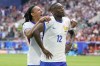 Randal Kolo Muani and Jules Kounde, left, of France, celebrate their first goal during a round of sixteen match between France and Belgium at the Euro 2024 soccer tournament in Duesseldorf, Germany, Monday, July 1, 2024. (AP Photo/Darko Vojinovic)