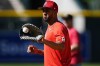 Washington Nationals' Eddie Rosario warms up for the team's baseball game against the Colorado Rockies on Friday, June 21, 2024, in Denver. (AP Photo/David Zalubowski)