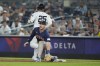 New York Yankees' Gleyber Torres (25) runs past Boston Red Sox's Romy Gonzalez, bottom, for a single during the fourth inning of a baseball game, Friday, July 5, 2024, in New York. Torres was injured on the play. (AP Photo/Frank Franklin II)