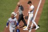 Pittsburgh Pirates starting pitcher Bailey Falter, right, walks to the dugout with a team trainer after removing himself in the third inning of a baseball game against the New York Mets in Pittsburgh, Saturday, July 6, 2024. (AP Photo/Gene J. Puskar)