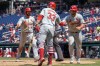 St. Louis Cardinals' Alec Burleson, left, and Willson Contreras, right, are congratulated by Brendan Donovan (33) after scoring during the fifth inning of a baseball game against the Washington Nationals at Nationals Park, Sunday, July 7, 2024, in Washington. (AP Photo/Mark Schiefelbein)