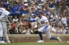Chicago Cubs' Miles Mastrobuoni, right, celebrates with teammate Michael Busch, left, at home plate after scoring on a Nico Hoerner sacrifice fly during the third inning of a baseball game against the Los Angeles Angels, Sunday, July 7, 2024, in Chicago. (AP Photo/Paul Beaty)