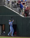 Texas Rangers right fielder Travis Jankowski, bottom, tries to catch a fly ball hit by Tampa Bay Rays' Randy Arozarena that a fan, top, catches in the seventh inning of a baseball game in Arlington, Texas, Sunday, July 7, 2024. Arozarena was called out on fan interference. (AP Photo/Tony Gutierrez)