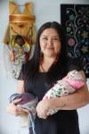 MIKE DEAL / FREE PRESS
                                Midwife Melissa Brown Sveinson with a handmade plush placenta and a doll swaddled in a traditional moss bag.