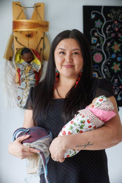 MIKE DEAL / FREE PRESS
                                Midwife Melissa Brown Sveinson with a handmade plush placenta and a doll swaddled in a traditional moss bag.