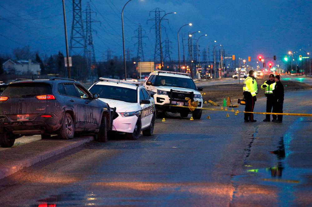 JOHN WOODS / FREE PRESS FILES
                                Police investigate the scene where Hudson was shot near the intersection of Lagimodiere Blvd at Fermor Ave., on April 8, 2020.