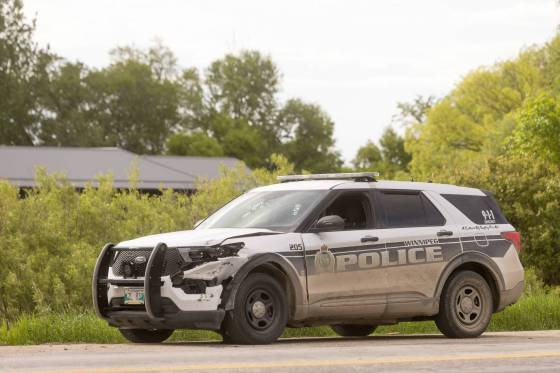 A Winnipeg Police Service vehicle riddled with bullet holes sits on the side of Hwy. 59 near the intersection of Provincial Road 305 near Niverville (Mike Deal / Free Press)
