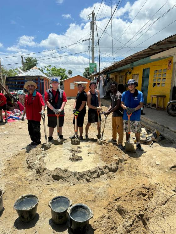 Volunteers from Manitoba mix sand for concrete as they build a house for a family in Puerto Plata, Dominican Republic. (Supplied)
