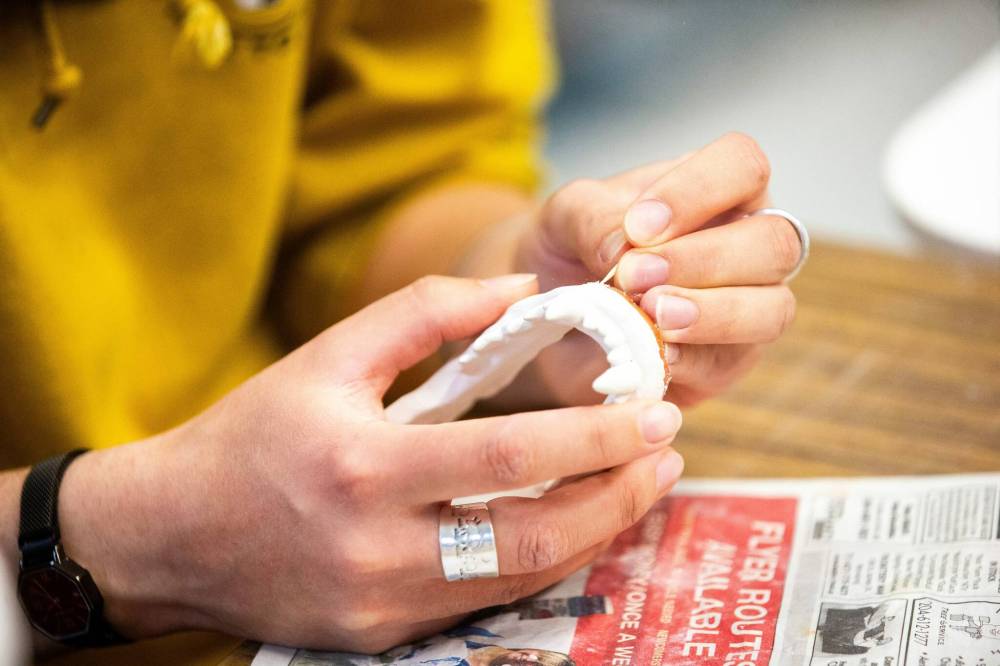 MIKAELA MACKENZIE / FREE PRESS
Artist-in-residence Jayme Syposh works on cleaning ceramic pieces at Artbeat Studio on Monday, April 29, 2024.