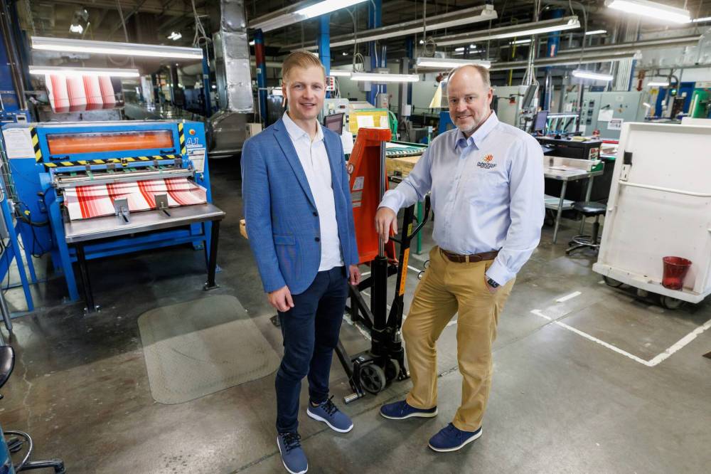 MIKE DEAL / FREE PRESS
Duha Group chief business officer Rick Duha (top left) and COO Douglas Crabb on the production floor of the 76-year-old colour swatch and colour marketing tools company at 750 Bradford St.