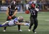 Patrick Doyle / THE CANADIAN PRESS
                                Bombers&rsquo; Nick Hallett dives at the feet of the Redblacks&rsquo; DeVonte Dedmon in the first half of Thursday&rsquo;s game in Ottawa.