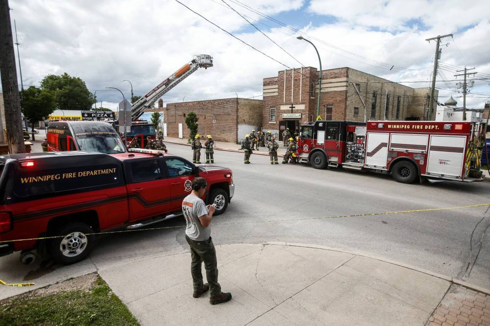 JOHN WOODS / FREE PRESS
Firefighters attend a fire in Holy Ascension Greek Orthodox Church Tuesday.