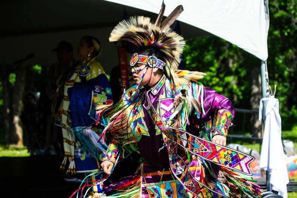 Grass dancer Dreyden Flettroulette dances at the Abinojii Mikanah renaming ceremony on Friday. (Mikaela MacKenzie / Free Press)