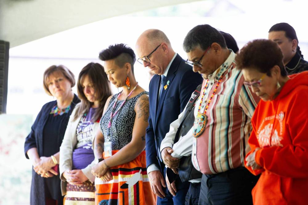Dignitaries, including Mayor Scott Gillingham (centre), stand for a moment of silence in remembrance of the children who didn’t come home. (Mikaela MacKenzie / Free Press)