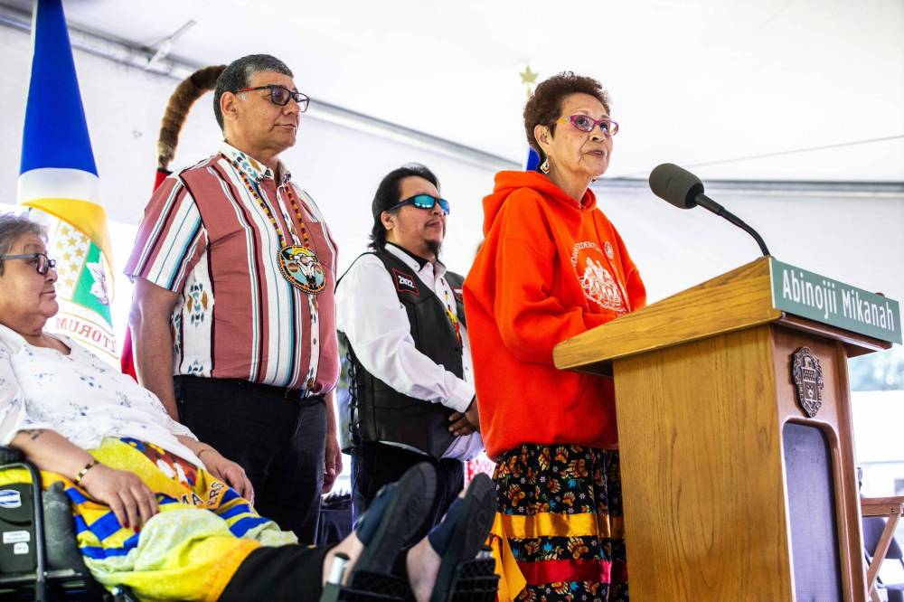 Elder Betty Ross speaks with other elders at the Abinojii Mikanah renaming ceremony on Friday. (Mikaela MacKenzie / Free Press)