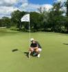 Supplied Photo
Aaron Cockerill retrieves his hole-in-one ball from the ninth hole Thursday at Niakwa Country Club.