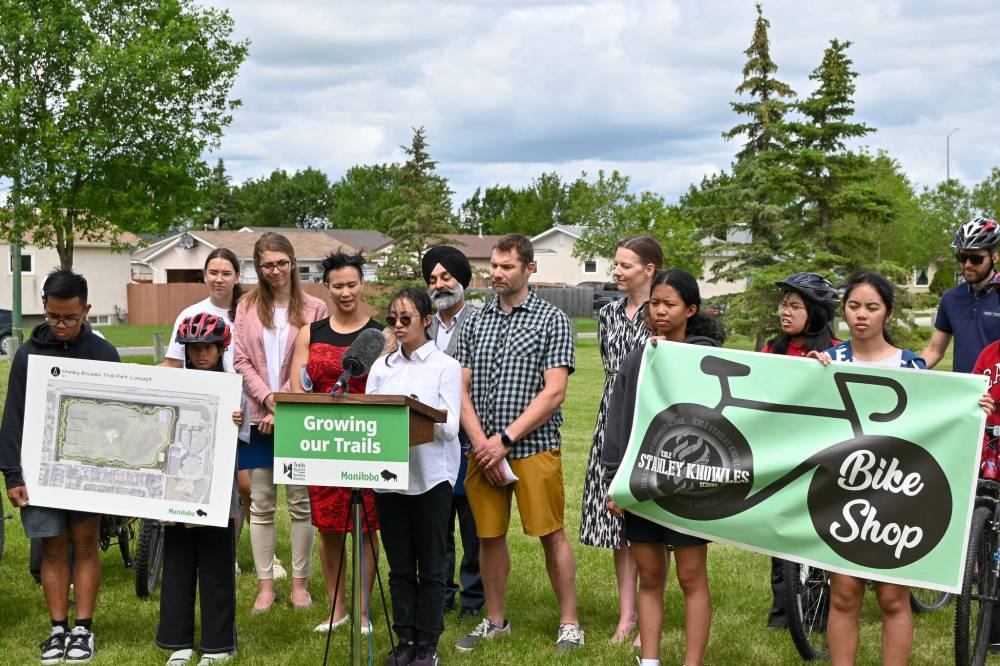 Matt Frank / Free Press
Ella Quinto (centre), a student at École Stanley Knowles School, speaks at an announcement for the construction of a new Fairgrove Park Community Trail on Tuesday.