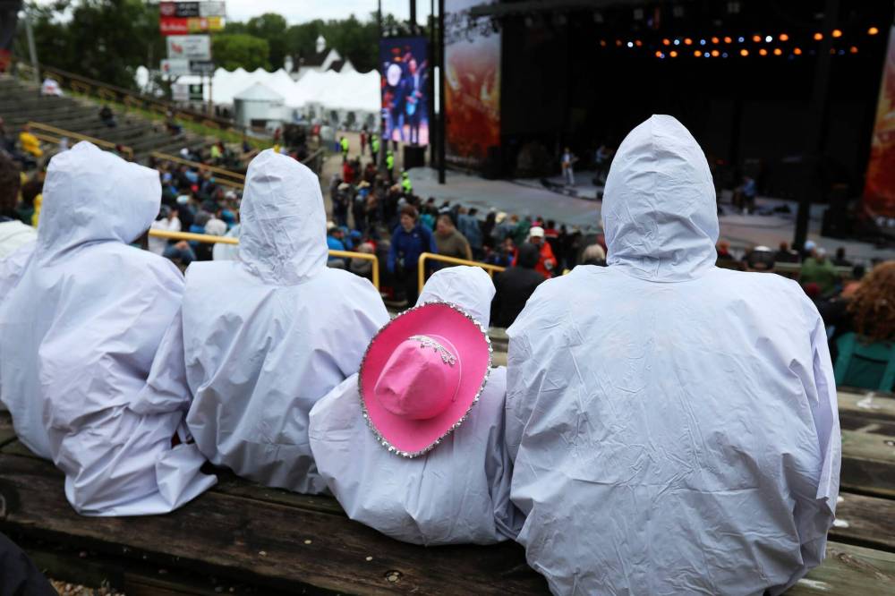 TIM SMITH / THE BRANDON SUN Bundled-up fans stay dry while watching Quinton Blair perform on the mainstage Friday evening.