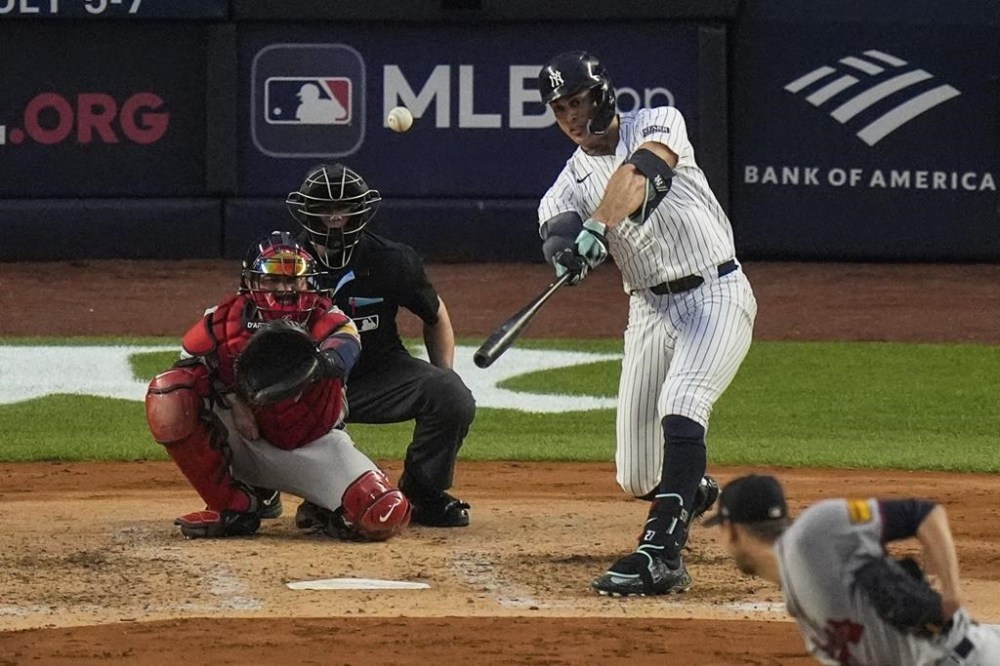 New York Yankees' Giancarlo Stanton, top right, hits a double during the fourth inning of a baseball game against the Atlanta Braves, Saturday, June 22, 2024, in New York. (AP Photo/Frank Franklin II)