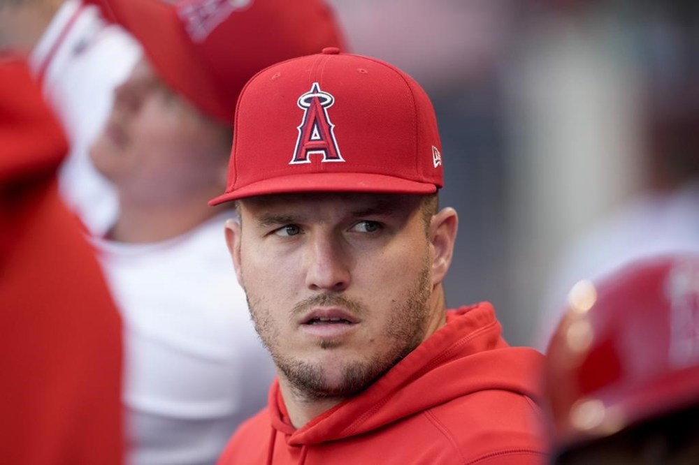 Los Angeles Angels center fielder Mike Trout sits in the dugout during the first inning of the team's baseball game against the Oakland Athletics, Tuesday, June 25, 2024, in Anaheim, Calif. (AP Photo/Ryan Sun)
