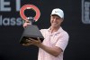 Cam Davis celebrates winning the Rocket Mortgage Classic golf tournament at Detroit Country Club, Sunday, June 30, 2024, in Detroit. (AP Photo/Paul Sancya)