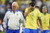 Brazil's coach Dorival Junior, right escorts off the field Lucas Paqueta (8) and teammates after their lost in a penalty shootout against Uruguay during a Copa America quarterfinal soccer match in Las Vegas, Saturday, July 6, 2024. (AP Photo/Julio Cortez)