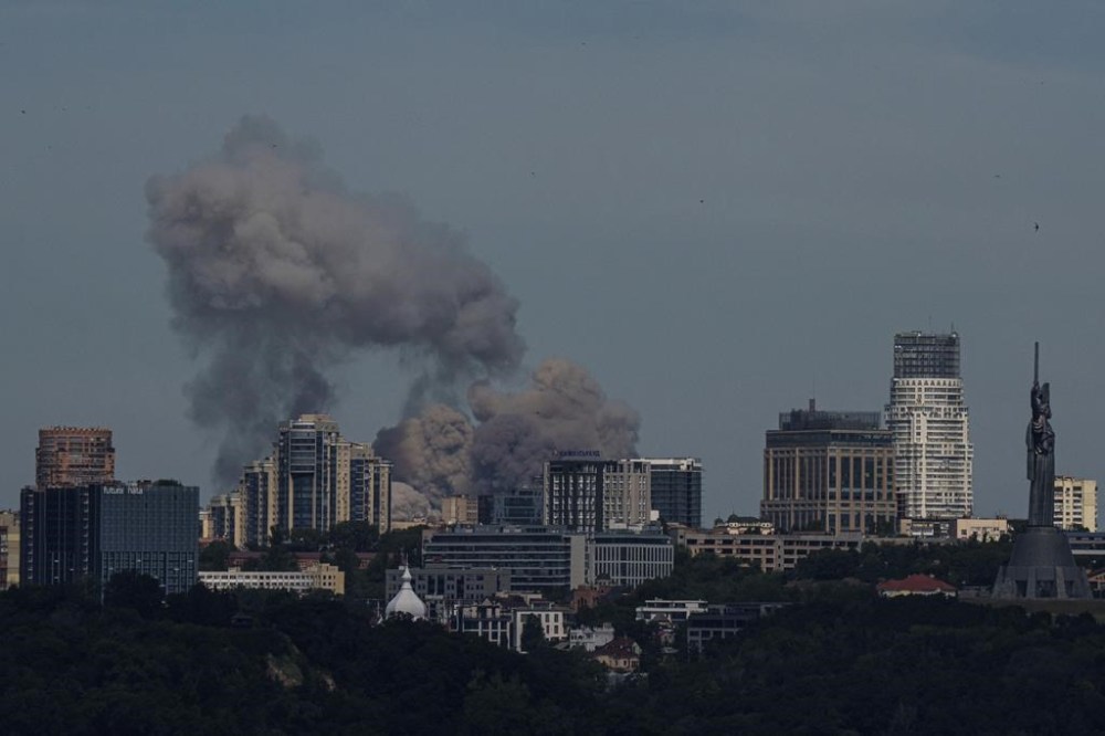 Smoke rises over the Kyiv skyline after a Russian attack, Monday, July 8, 2024. Russian forces launched multiple ballistic and cruise missiles against Ukrainian targets on Monday, Ukraine’s air force said, with explosions felt and heard across the capital, Kyiv. (AP Photo/ Evgeniy Maloletka)