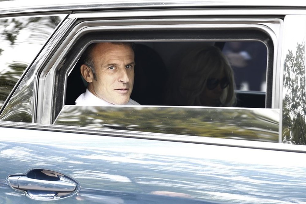French President Emmanuel Macron and his wife Brigitte Macron leave after voting for the second round of the legislative elections in Le Touquet-Paris-Plage, northern France, Sunday July 7 2024. Voting has begun in mainland France on Sunday in pivotal runoff elections that could hand a historic victory to Marine Le Pen's far-right National Rally and its inward-looking, anti-immigrant vision — or produce a hung parliament and political deadlock. (Mohammed Badra, Pool via AP)