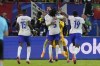 Theo Hernandez of France, top center, and Jules Kounde celebrate after Hernandez scored the deciding goal in a shootout to win a quarter final match between Portugal and France at the Euro 2024 soccer tournament in Hamburg, Germany, Friday, July 5, 2024. (AP Photo/Frank Augstein)