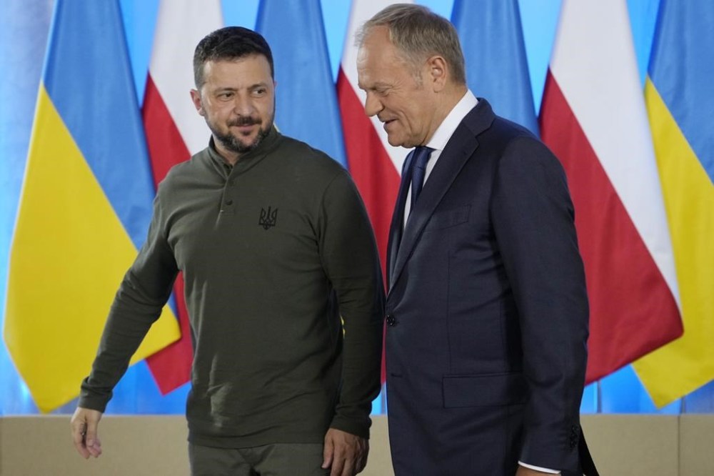 Poland's Prime Minister Donald Tusk, right, and Ukrainian President Volodymyr Zelenskyy walk during their meeting in Warsaw, Poland, Monday, July 8, 2024. (AP Photo/Czarek Sokolowski)
