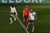 Switzerland's Silvan Widmer, center, heads the ball away from England's Luke Shaw, right, during a quarterfinal match between England and Switzerland at the Euro 2024 soccer tournament in Duesseldorf, Germany, Saturday, July 6, 2024. (AP Photo/Hassan Ammar)