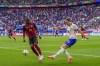 France's Adrien Rabiot, right, clears the ball next to Belgium's Dodi Lukebakio during a round of sixteen match between France and Belgium at the Euro 2024 soccer tournament in Dusseldorf, Germany, Monday, July 1, 2024. France won 1-0. (AP Photo/Hassan Ammar)