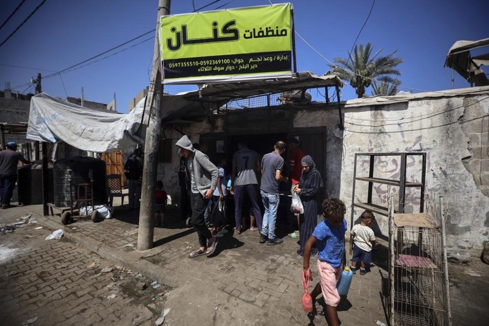 Palestinian manufacturers are bottling locally-made cleaning products in Deir el-Balah in the central Gaza Strip on July 8, 2024, amid a lack of raw materials and sanitary supplies as the conflict continues between Israel and the Hamas militant group in the besieged Palestinian territory. (Photo by Majdi Fathi/NurPhoto via AP)