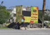 A woman walks past a food stall destroyed by Hurricane Beryl in the fishing settlement of Rocky Point, Clarendon, Jamaica, Thursday, July 4, 2024. (AP Photo/Collin Reid)