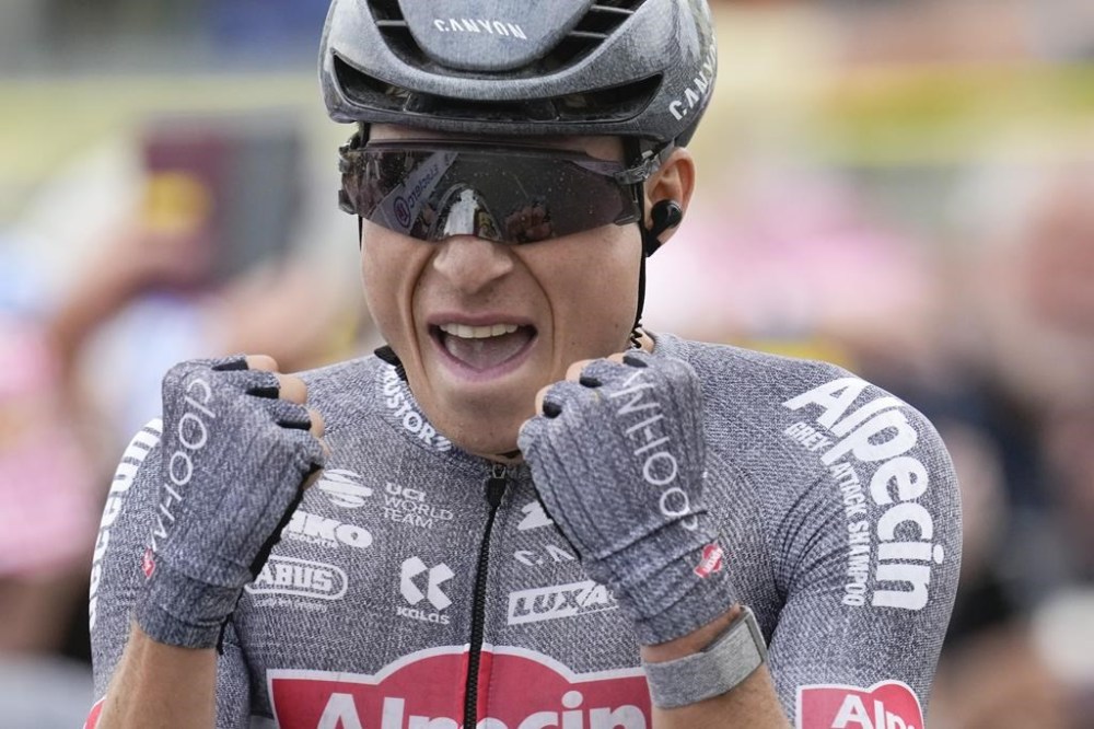 Belgium's Jasper Philipsen celebrates winning the tenth stage of the Tour de France cycling race over 187.3 kilometers (116.4 miles) with start in Orleans and finish in Saint-Amand-Montrond, France, Tuesday, July 9, 2024. (AP Photo/Jerome Delay)
