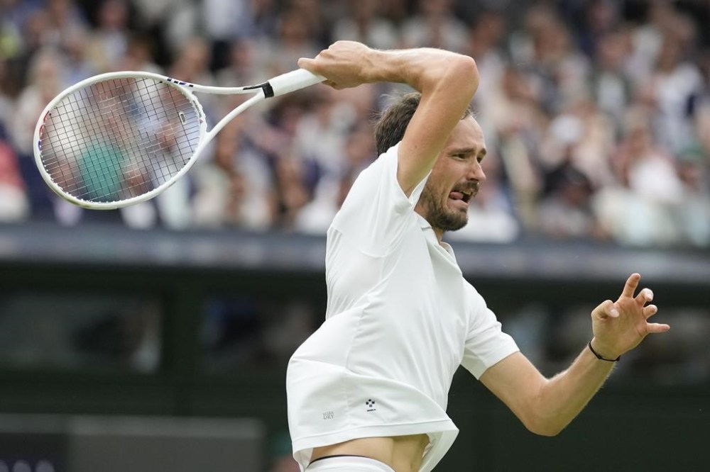 Daniil Medvedev of Russia plays a forehand return to Jannik Sinner of Italy during their quarterfinal match at the Wimbledon tennis championships in London, Tuesday, July 9, 2024. (AP Photo/Alberto Pezzali)