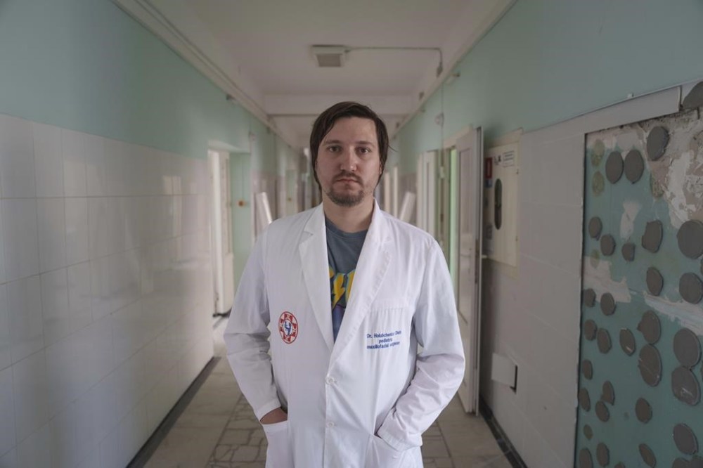 Doctor Oleh Holubchenko poses in the corridor of the Okhmatdyt children's hospital that was hit by Russian missiles on Monday, in Kyiv, Ukraine, Tuesday, July 9, 2024. The toll of Russia’s heaviest bombardment of Kyiv in almost four months — one of the deadliest of the war — shows the devastating human cost of Russia’s improved targeting tactics. (AP Photo/Evgeniy Maloletka)