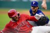 Los Angeles Angels' Taylor Ward (3) is tagged out by Texas Rangers third baseman Josh Smith after attempting to reach third on a fielding error by right fielder Derek Hill during the third inning of a baseball game Tuesday, July 9, 2024, in Anaheim, Calif. (AP Photo/Ryan Sun)