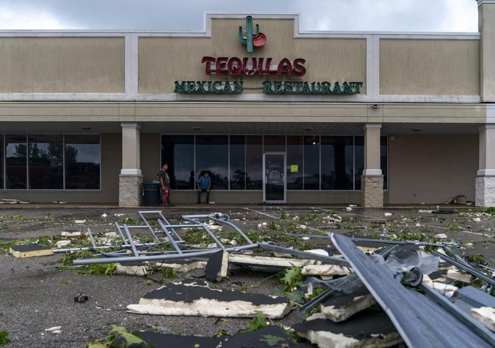 A cart return is mangled outside Tequilas Mexican Restaurant in the Southwind Plaza after an apparent tornado ripped through Mount Vernon, Ind., Tuesday, July 9, 2024. (MaCabe Brown/Evansville Courier & Press via AP)