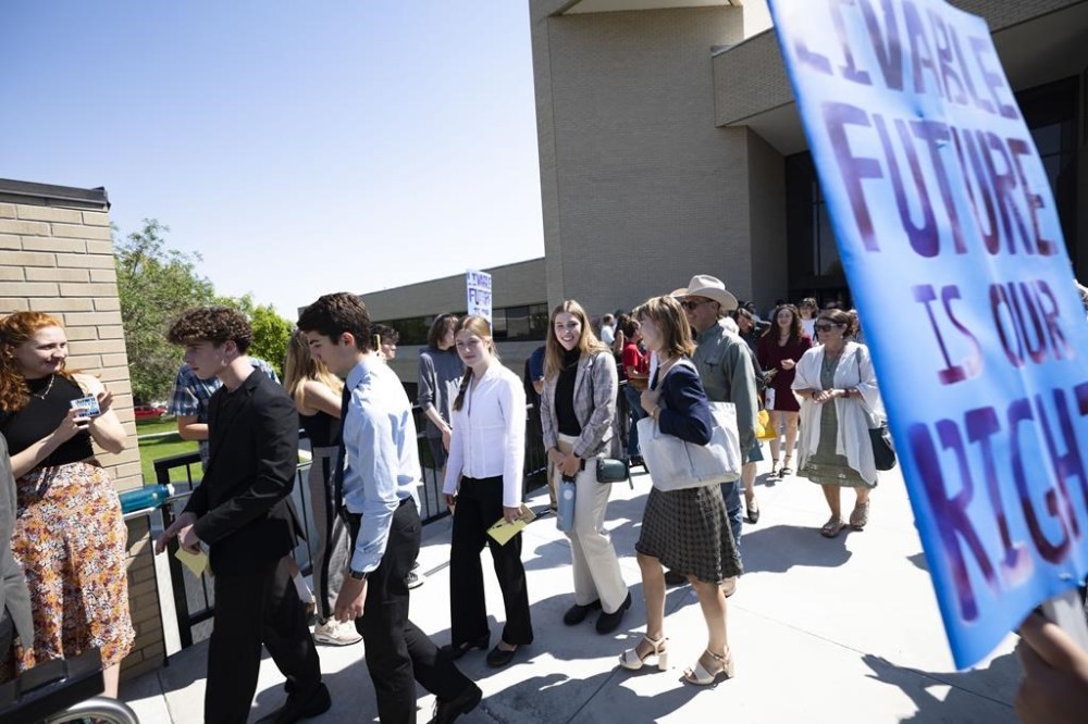 Youth plaintiffs in the Held v. Montana climate case leave the Montana Supreme Court, Wednesday, July 10, 2o24, in Helena, Mont., after oral arguments before the state's highest court. Attorneys for Republican officials pressed Montana's Supreme Court on Wednesday to overturn a landmark climate ruling that said the state was violating residents' constitutional right to a clean environment by allowing oil, gas and coal projects without regard for global warming. (Thom Bridge/Independent Record via AP)