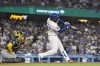 Los Angeles Dodgers' Teoscar Hernández, right, hits as RBI double as Milwaukee Brewers catcher William Contreras watches during the eighth inning of a baseball game Friday, July 5, 2024, in Los Angeles. (AP Photo/Mark J. Terrill)