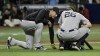 New York Yankees manager Aaron Boone, left, checks on DJ LeMahieu (26) after he was hit in the throat by a foul ball while batting during the seventh inning of a baseball game against the Tampa Bay Rays Wednesday, July 10, 2024, in St. Petersburg, Fla. (AP Photo/Steve Nesius)