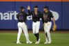 New York Mets outfielders Harrison Bader, left, Brandon Nimmo and Tyrone Taylor celebrate after winning a baseball game against the Washington Nationals, Wednesday, July 10, 2024, in New York. (AP Photo/Pamela Smith)