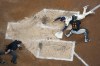 Milwaukee Brewers' Brice Turang (2) slides safely into home plate past the tag of Pittsburgh Pirates' Joey Bart to score a run on a double hit by Brewers' William Contreras during the fourth inning of a baseball game Wednesday, July 10, 2024, in Milwaukee. (AP Photo/Aaron Gash)