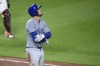 Chicago Cubs' Cody Bellinger reacts as he walks to first base after he was hit by a pitch by Baltimore Orioles relief pitcher Cionel Perez during the seventh inning of a baseball game, Wednesday, July 10, 2024, in Baltimore. (AP Photo/Nick Wass)