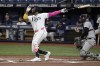 New York Yankees catcher Austin Wells, right, watches as Tampa Bay Rays' Yandy Díaz hits a fly ball off the catwalk in center field during the first inning of a baseball game Thursday, July 11, 2024, in St. Petersburg, Fla. (AP Photo/Steve Nesius)