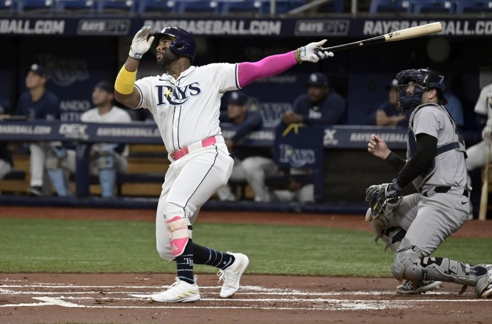 New York Yankees catcher Austin Wells, right, watches as Tampa Bay Rays' Yandy Díaz hits a fly ball off the catwalk in center field during the first inning of a baseball game Thursday, July 11, 2024, in St. Petersburg, Fla. (AP Photo/Steve Nesius)