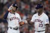 Houston Astros' Jeremy Peña, left, fist-bumps first base coach Dave Clark (23) after hitting an RBI single during the first inning of a baseball game against the Miami Marlins, Thursday, July 11, 2024, in Houston. (AP Photo/Kevin M. Cox)