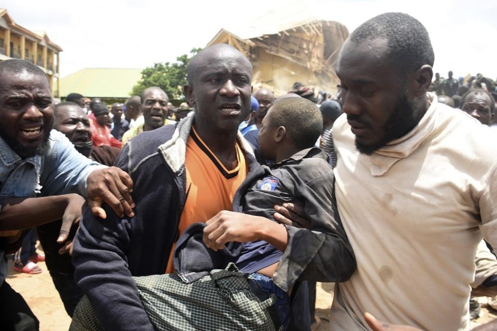 A student is rescued from the rubble of a collapsed two-storey building in Jos, Nigeria, Friday, July, 12, 2024. At least 12 students have been killed after a school building collapsed and trapped them in northern Nigeria, authorities said on Friday. (AP Photos)